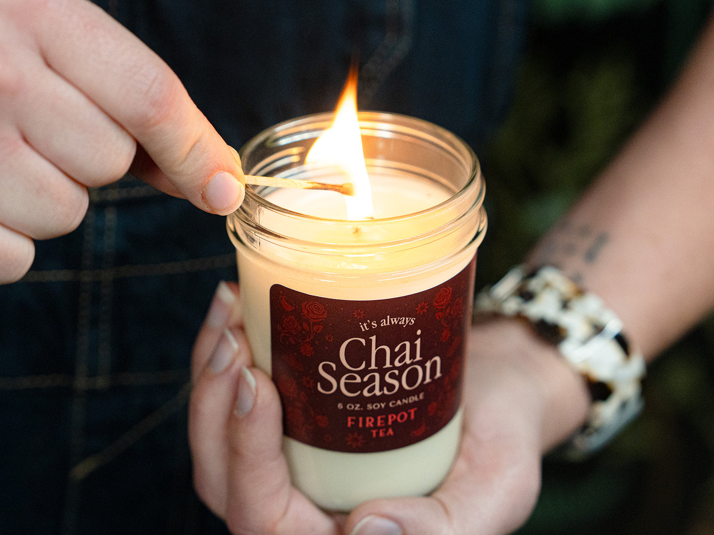 image of 6oz soy chai scented candle lit with a match 