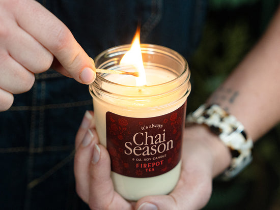 image of 6oz soy chai scented candle lit with a match 